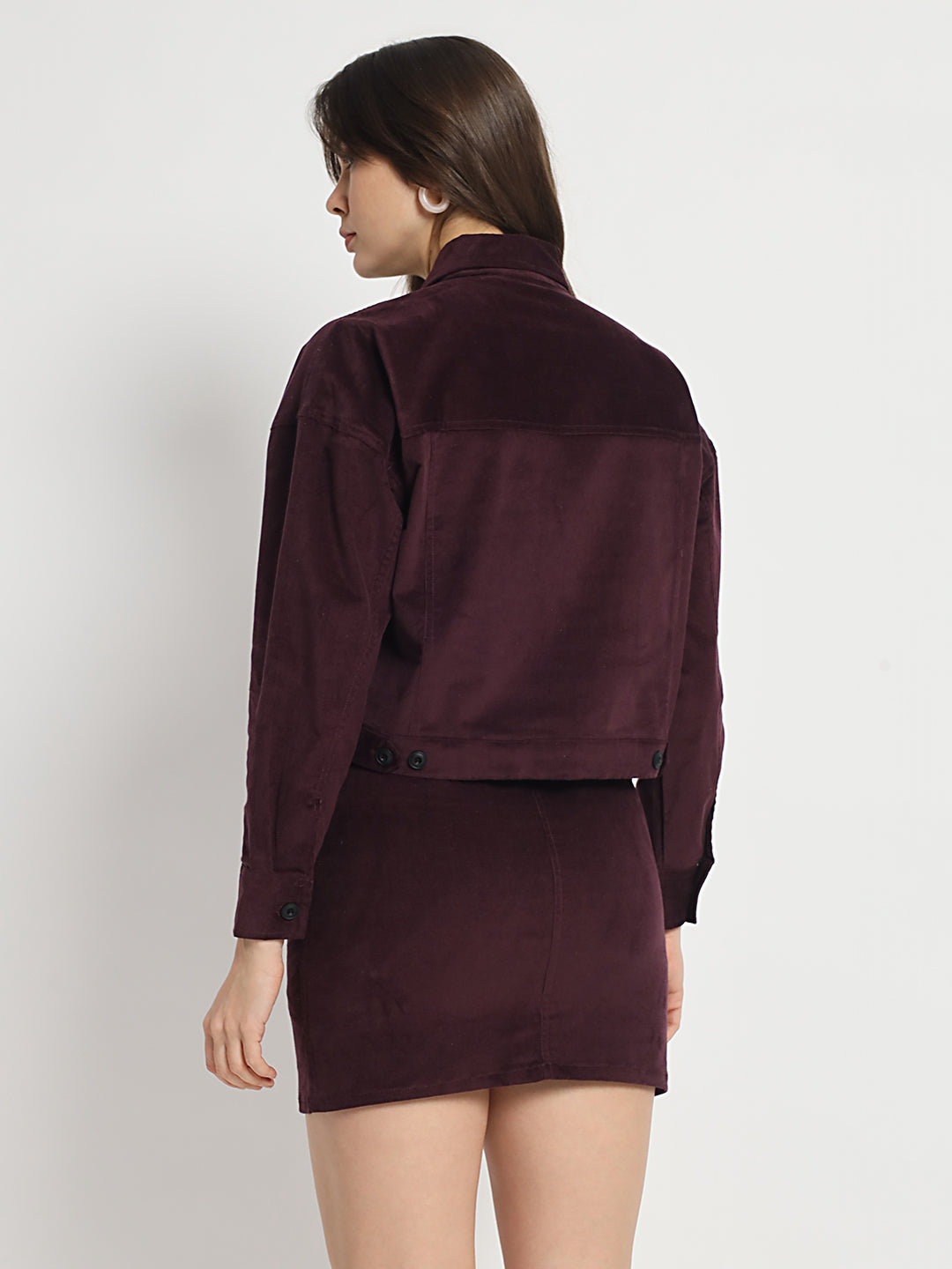 a woman standing on a beach holding a tennis racquet