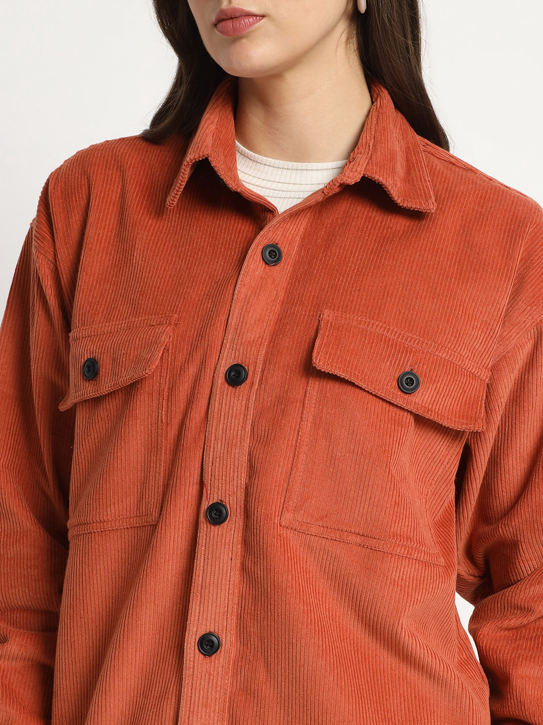 a woman in a red jacket is smiling