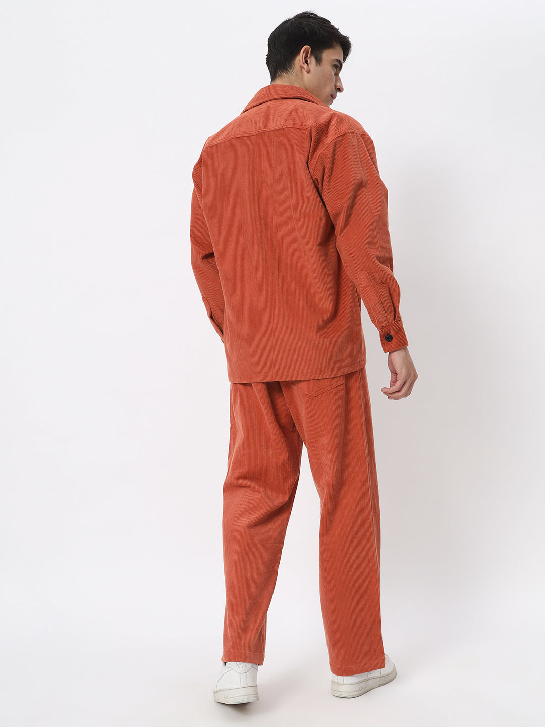 a woman in a red jacket on skis in the snow