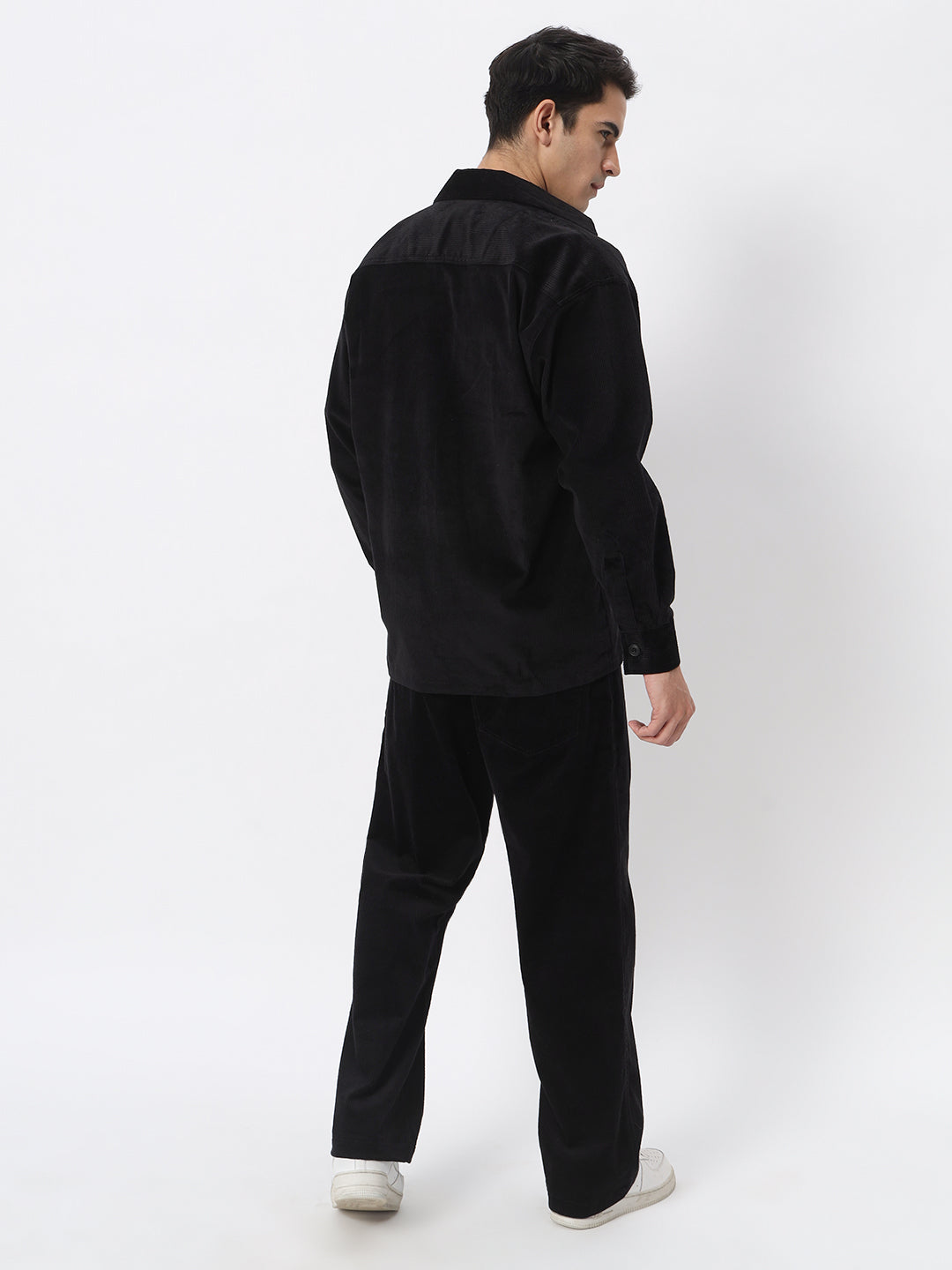 a man is standing in a white suit