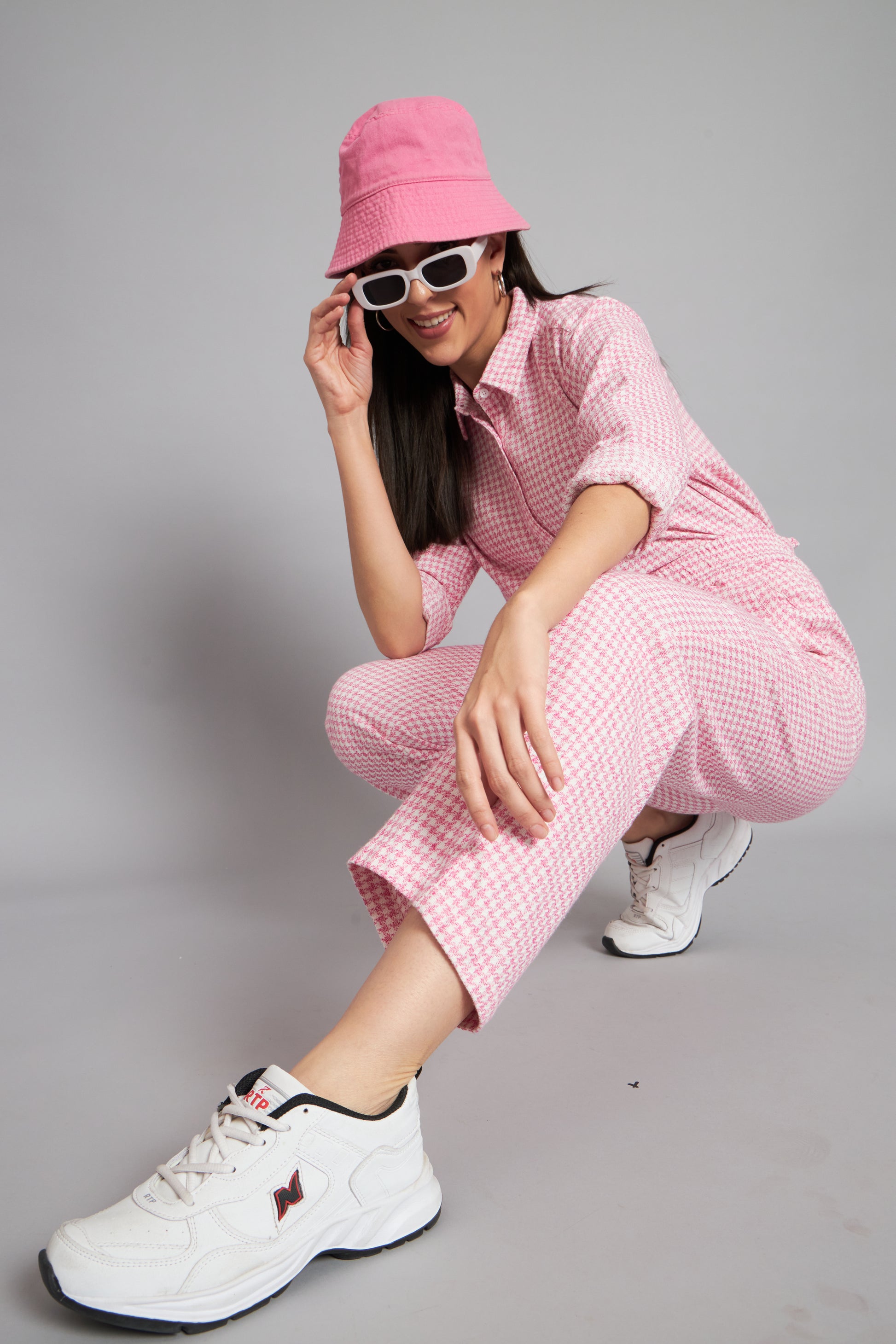 a woman in a pink dress is holding a cell phone 